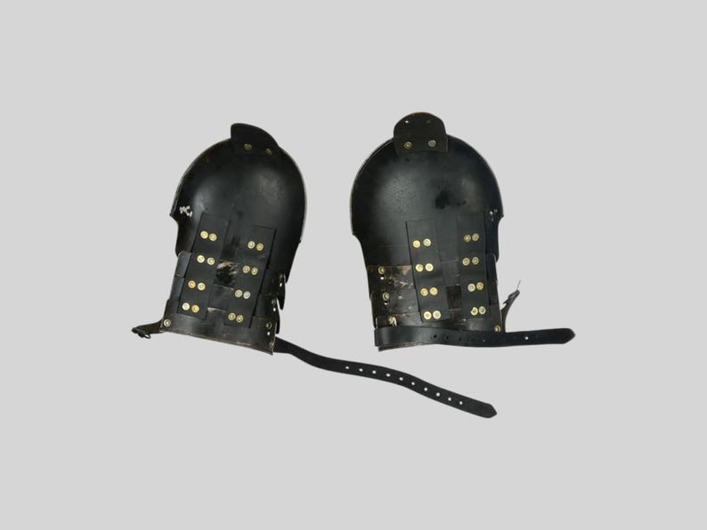 Adjustable medieval pauldrons with leather straps and rolled steel edges