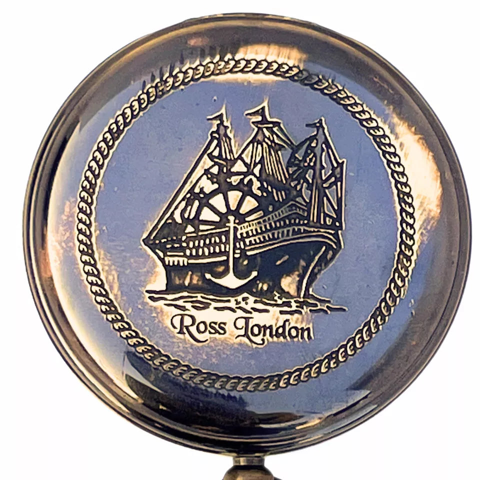 Close-up of Artisans Hub brass compass showing intricate engraved details and vintage surface