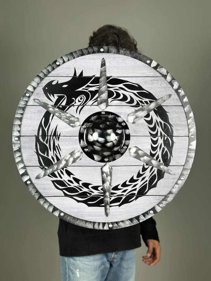 Person picking up Artisans Hub Dragon Shield, authentic Viking cosplay accessory