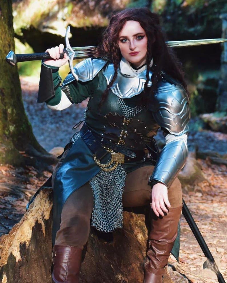 Close-up of white rose emblem on shoulder armor with sculpted steel
