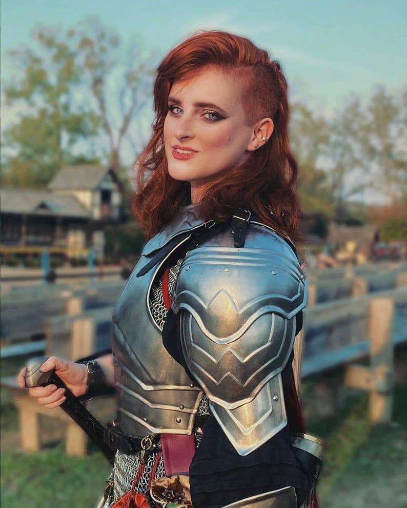 Side view showing chainmail skirt and polished steel pauldrons