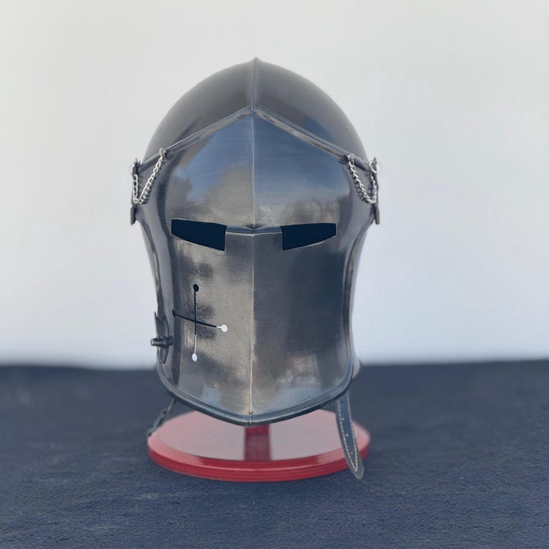 Side view of authentic Medieval Knight Steel Barbuta Helmet with leather straps