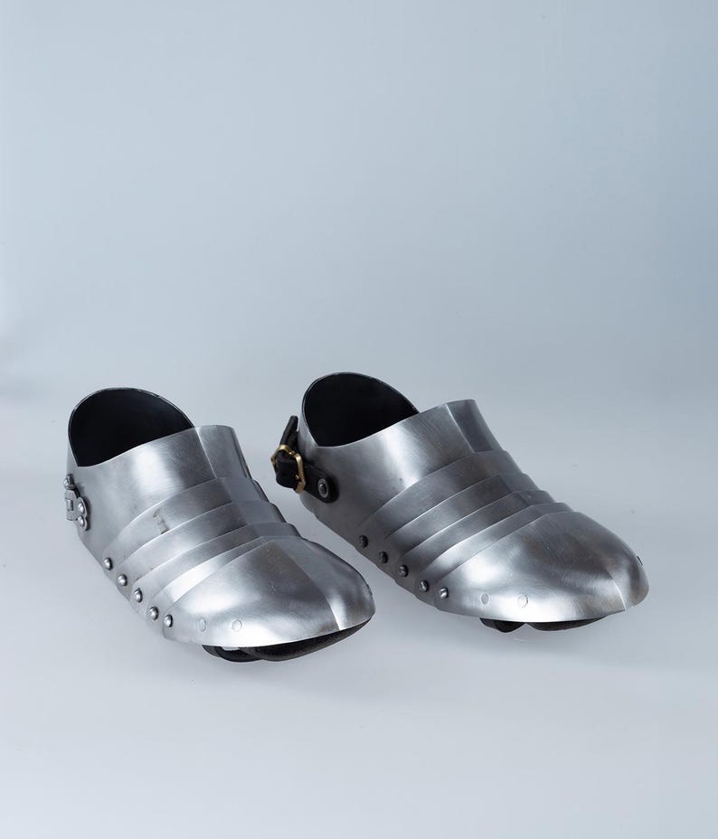 Side profile of authentic steel blunt toe knight sabatons with leather straps