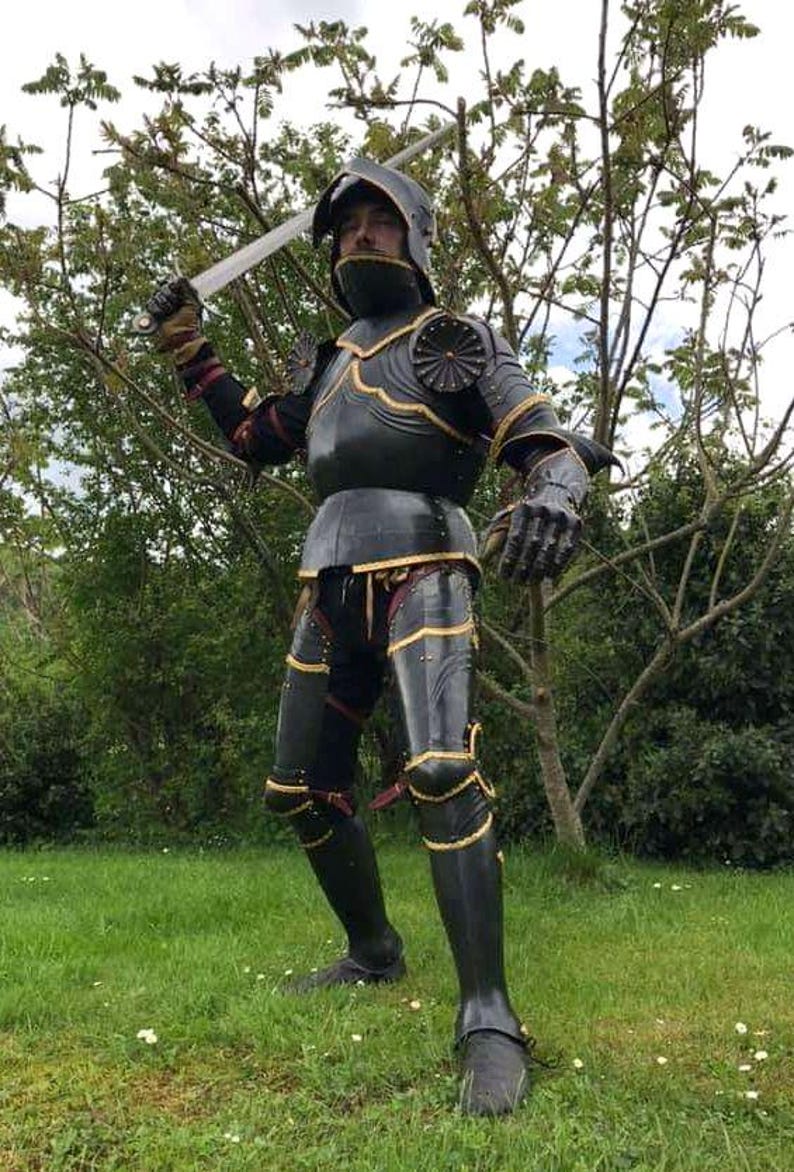 Close-up of Black Lion Gothic Knight Armor helmet and fluted chestplate with gold detailing