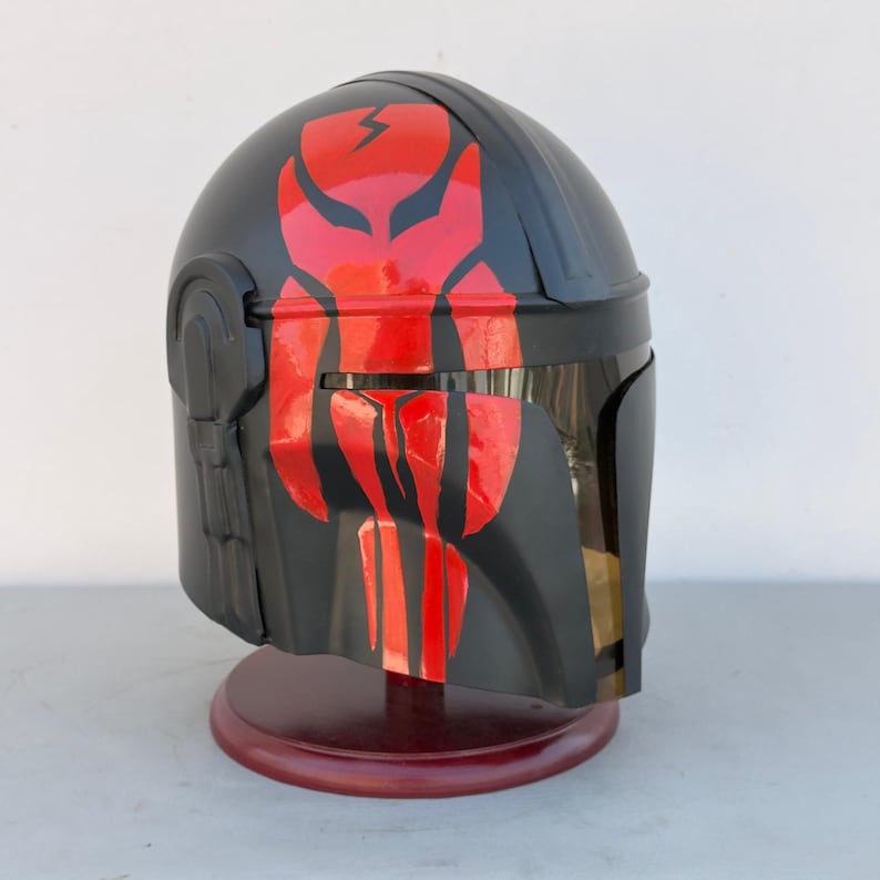 Side angle of Boba Fett cosplay helmet in black and red steel for Star Wars costume fans
