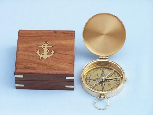 Close-up of the rosewood box featuring a brass anchor on top, holding the compass