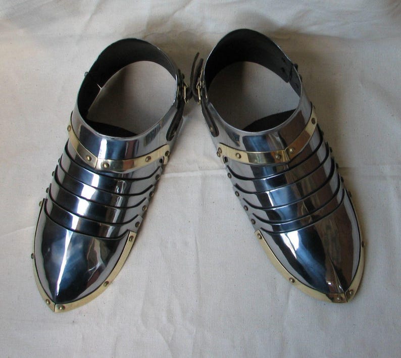 Close-up of brass steel sabatons showing fine craftsmanship and rolled edges