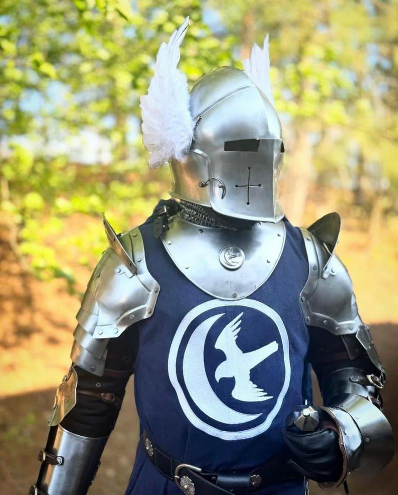 Image of the flexible chainmail coif included with the armor set, providing additional neck and shoulder protection under the helmet.