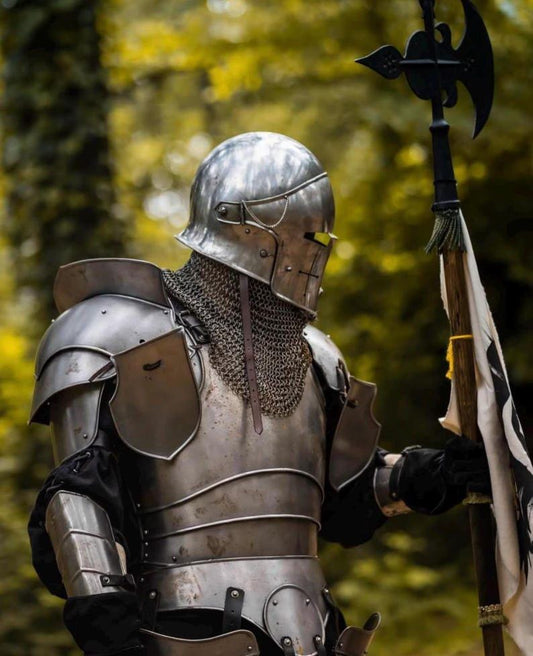Close-up of a crusader-style steel helmet with cross slit design, paired with a chainmail coif for neck and shoulder protection.