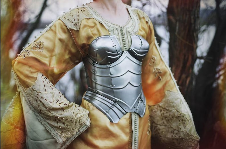 Close-up of fantasy steel leg greaves from women’s medieval armor