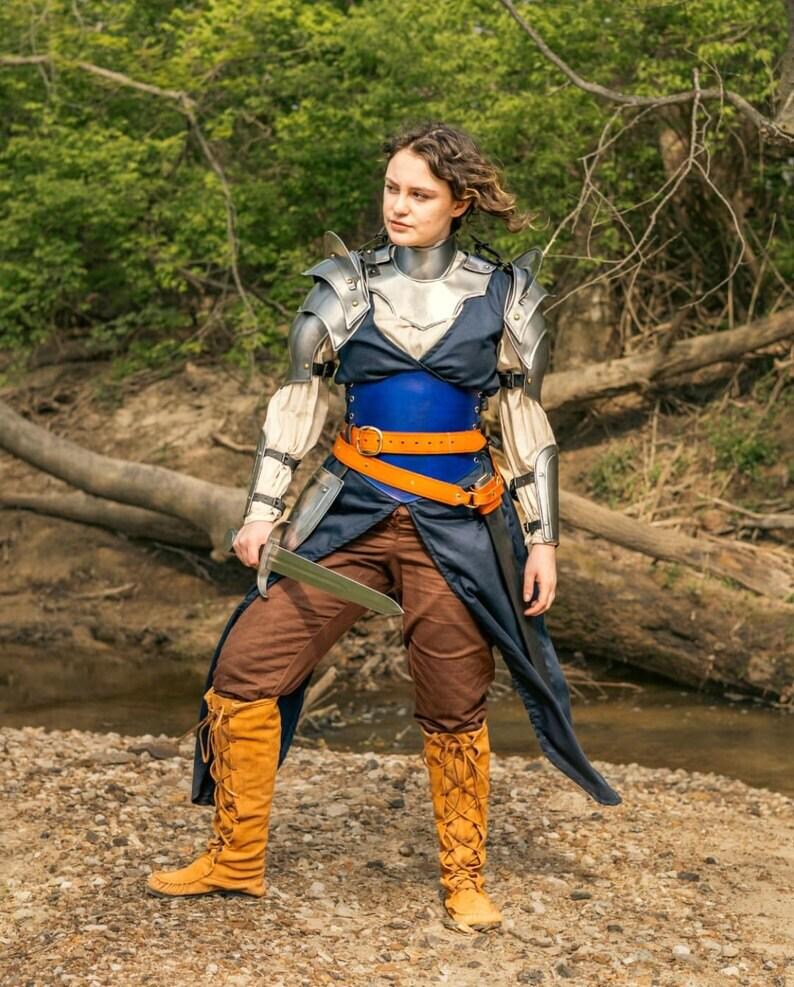 Heroic pose with optional sword accessory paired with the Lady of Steel armor, styled for fantasy cosplay or LARP settings.