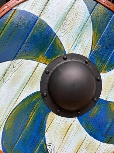 Viking wooden shield displayed on wall as Norse-themed medieval decor