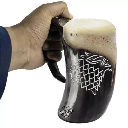 Close-up of wolf carving on Viking drinking horn mug for beer and ale