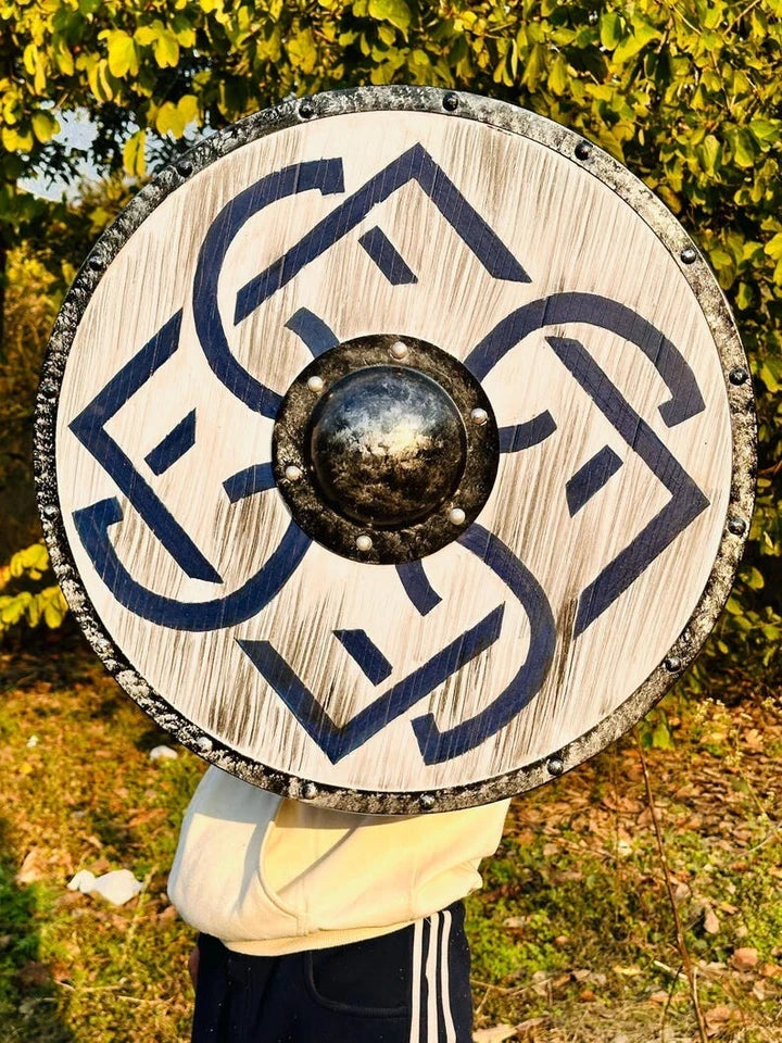 Close-up of handcrafted wooden texture and painted design on Viking shield