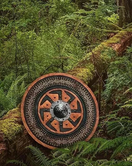 Close-up of handmade Viking wooden shield showing carved detail and wood texture