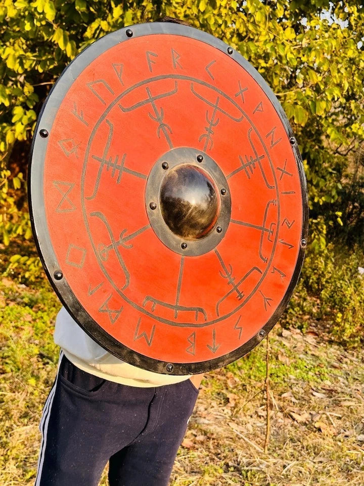 Close-up of carved wood detail on handcrafted Viking shield