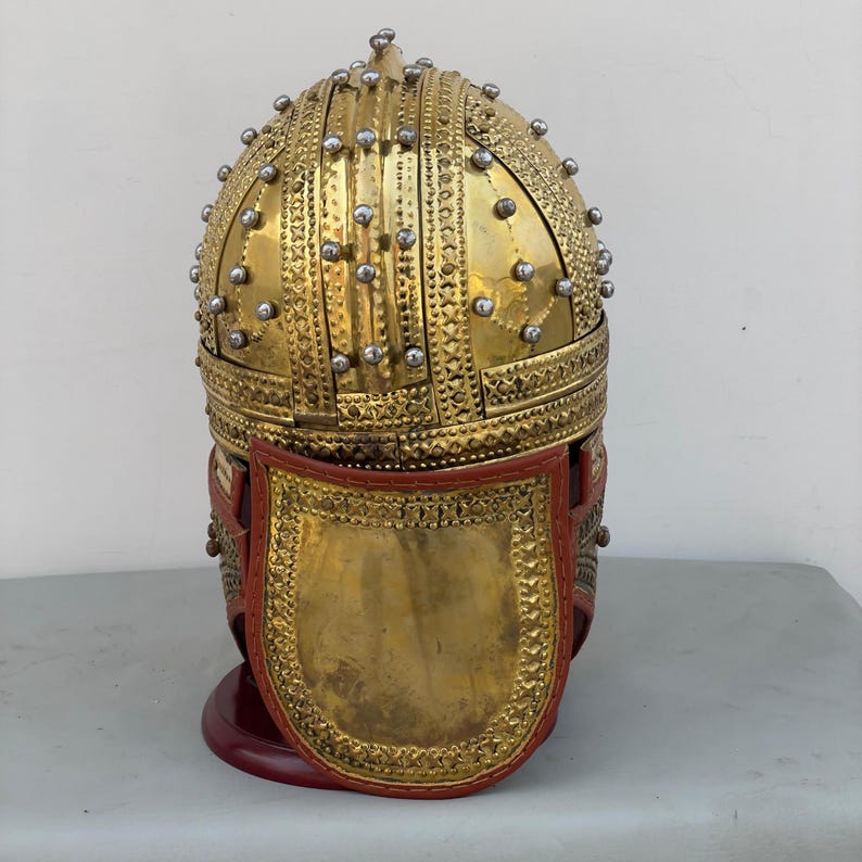 Detailed shot of historical brass knight helmet showcasing handcrafted Deurne-inspired design elements.