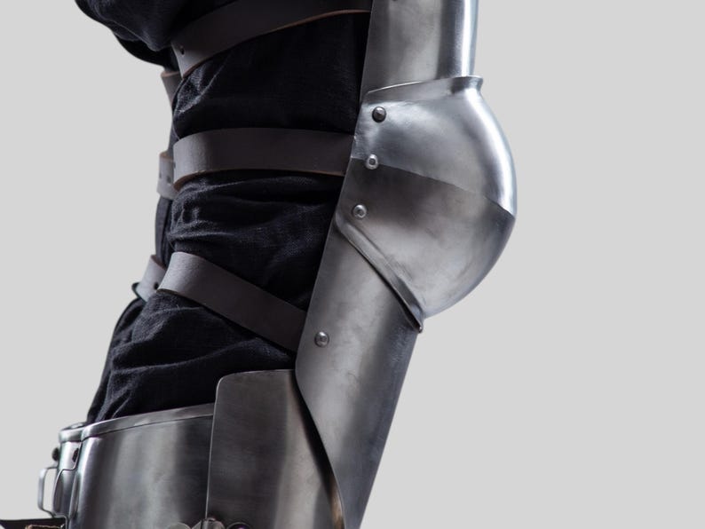 Historical replica of medieval leg armor with detailed knee caps