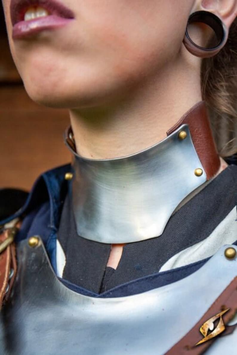 Close-up of polished steel lady armor chest plate and gorget