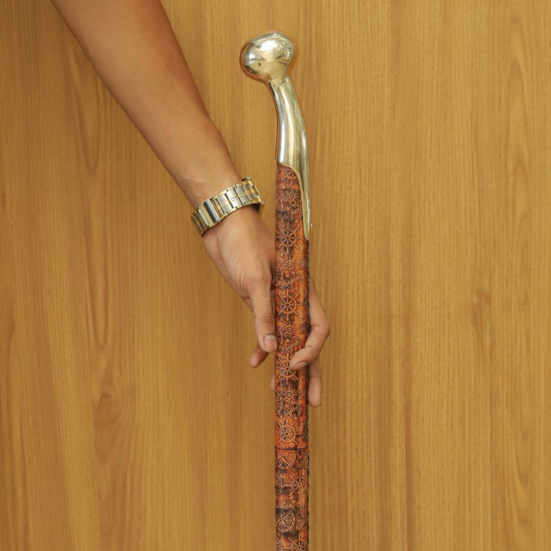 Classic wooden cane with detailed hand-carved design and sturdy brass grip