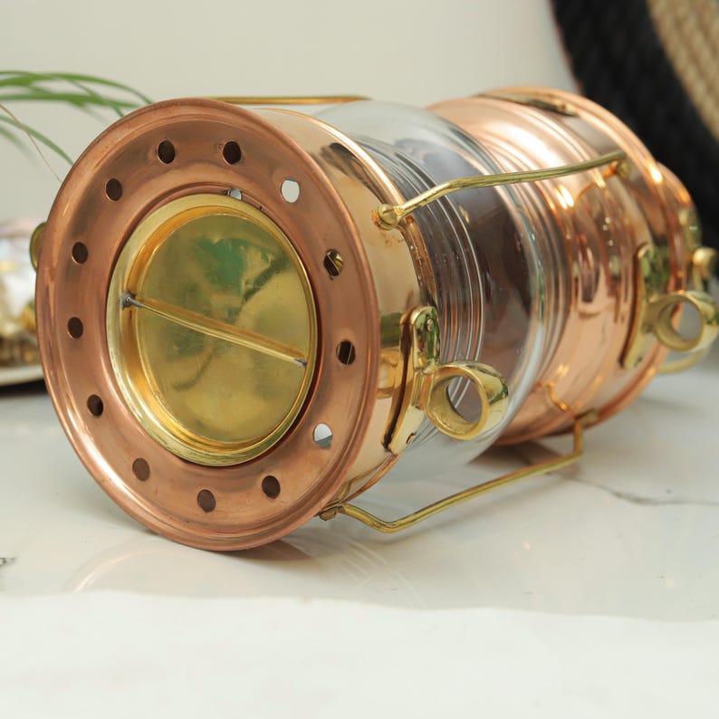 Maritime anchor light with polished brass finish and thick glass lens