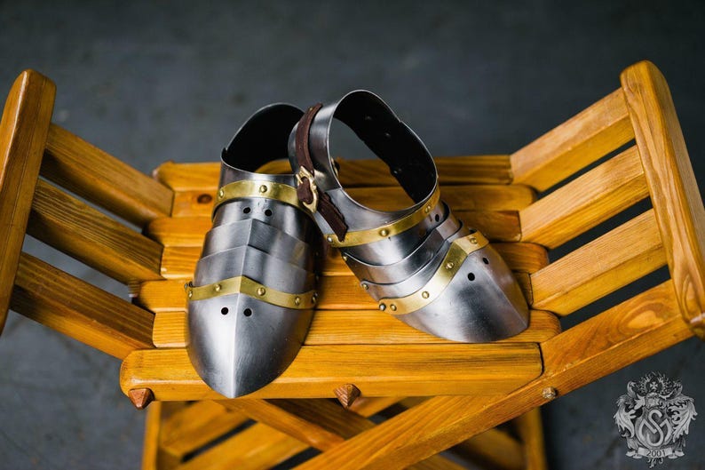 Pair of medieval knight sabatons on display, ideal for reenactment or cosplay
