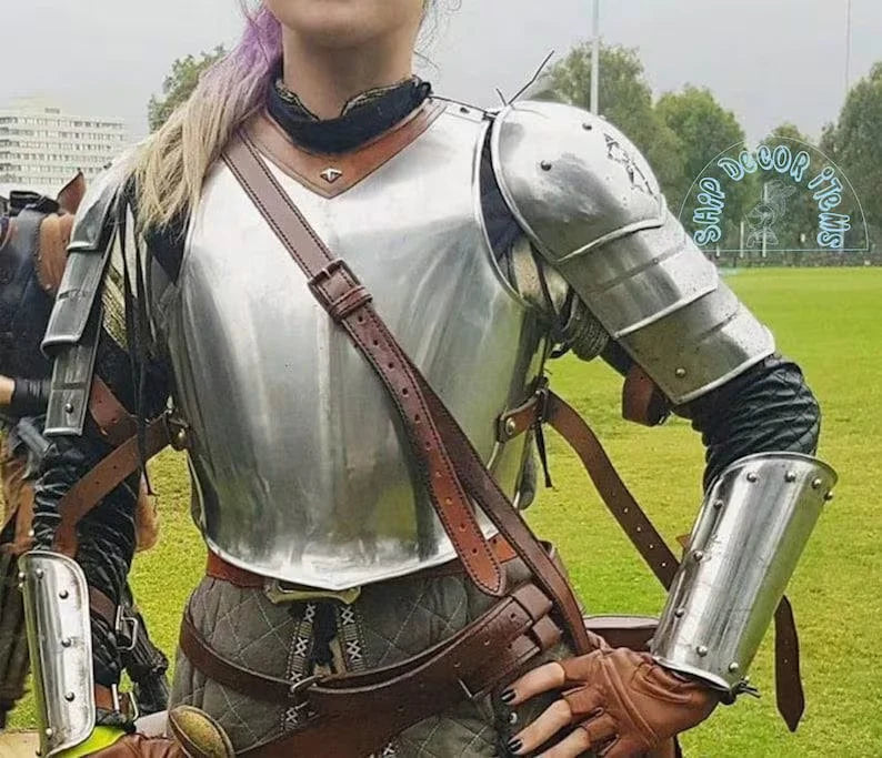Detailed close-up of the breastplate from the lady’s medieval armor showing polished steel and artisan craftsmanship.