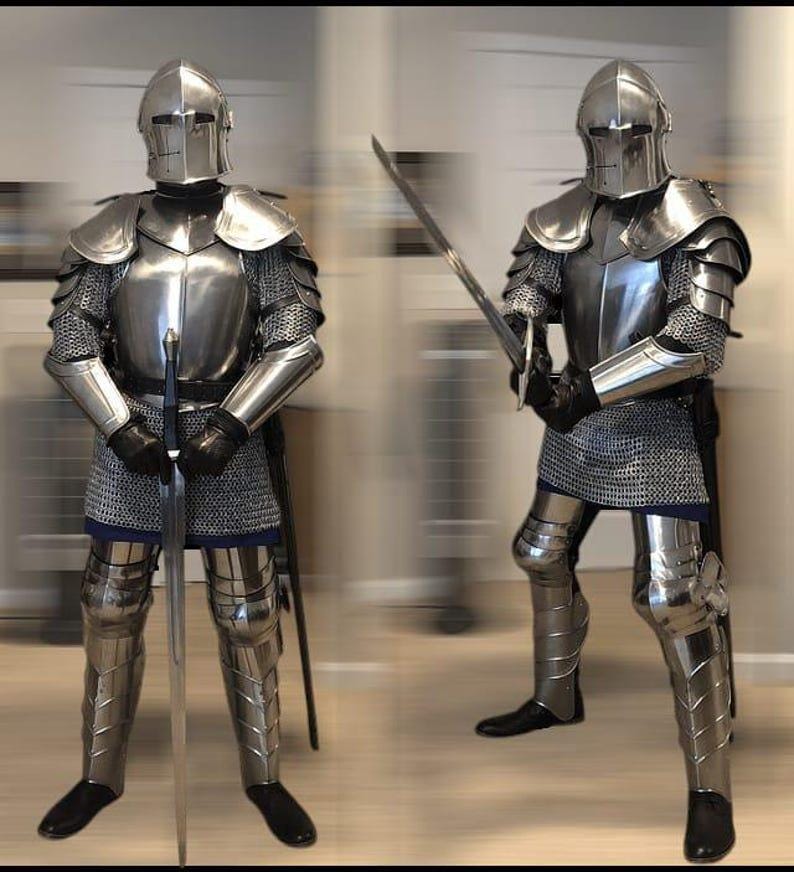 Close-up of fully enclosed medieval knight helmet with visor slits made from polished steel.