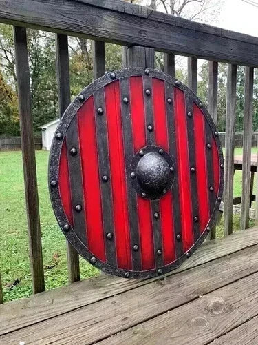 Handmade Viking shield used as wall decor in a medieval-themed setting