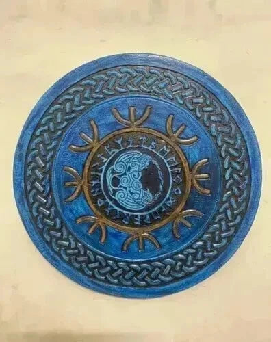 Close-up of wood grain and hand-painted detailing on Viking round shield