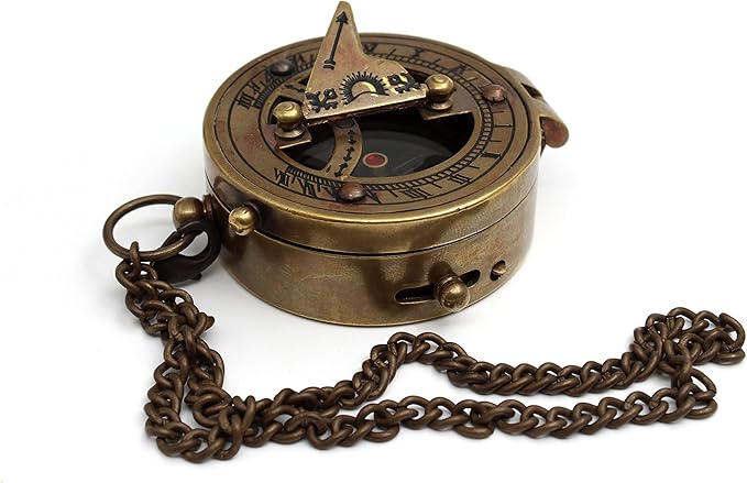 Brass sundial compass placed outdoors on a rock, ideal for camping or hiking.