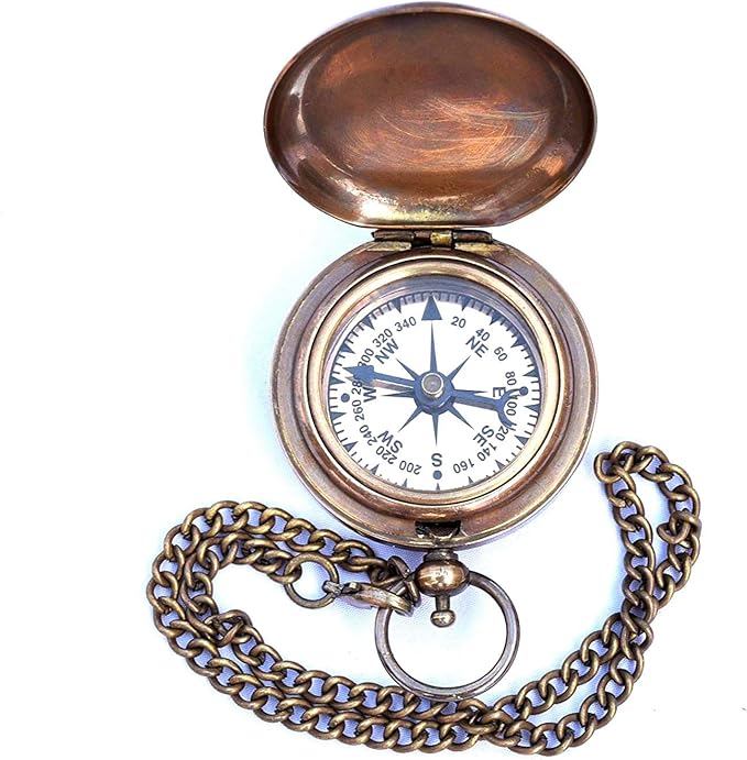 Portable brass pocket compass resting on its leather case