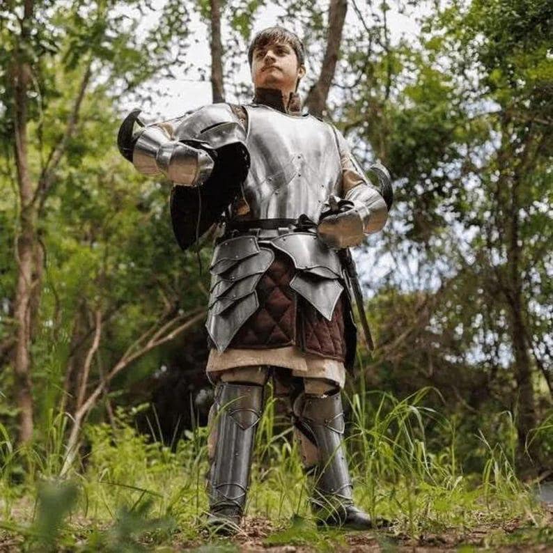 Detailed image of Rikomer full-body suit highlighting helmet design, rivets, and polished steel craftsmanship.
