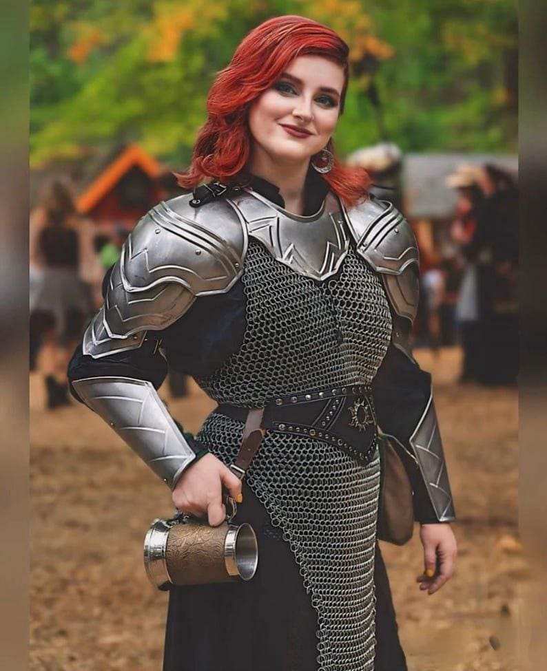 Close-up of the sculpted silver cuirass and gorget, designed to fit the feminine form with layered steel detailing and polished finish.