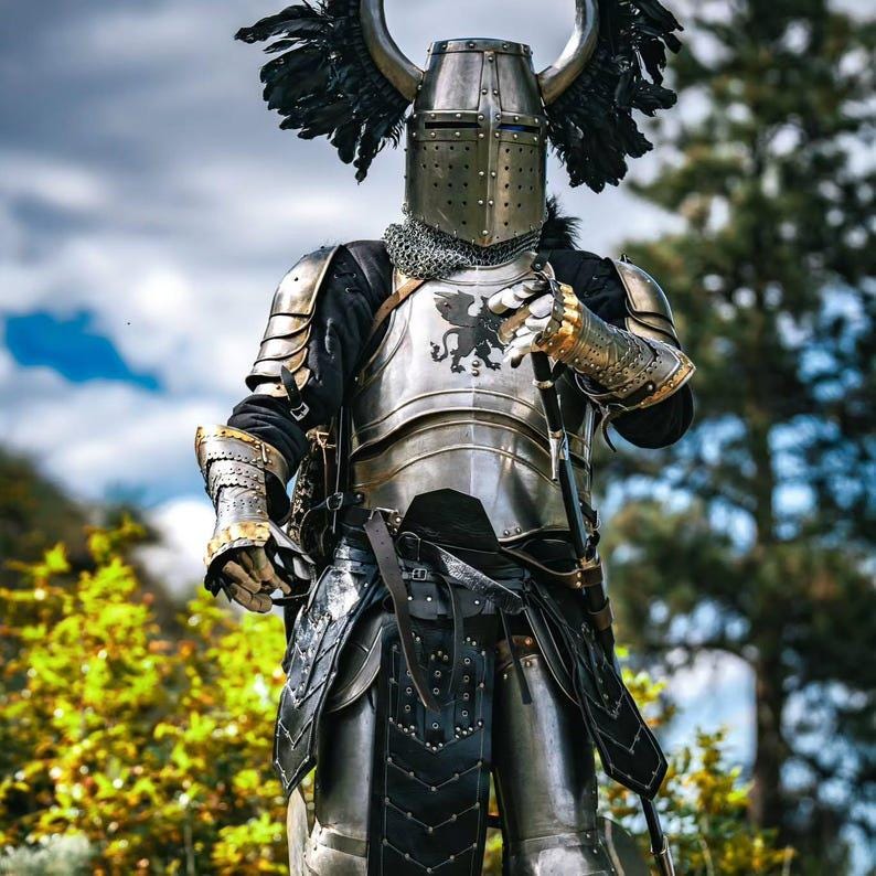 Side view of layered steel pauldrons and integrated gorget attached with leather straps for shoulder and neck protection.