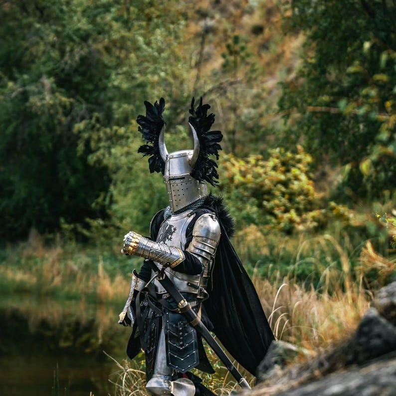 Thigh and leg armor including tassets and greaves with riveted leather and steel construction, designed for battle reenactment and cosplay.