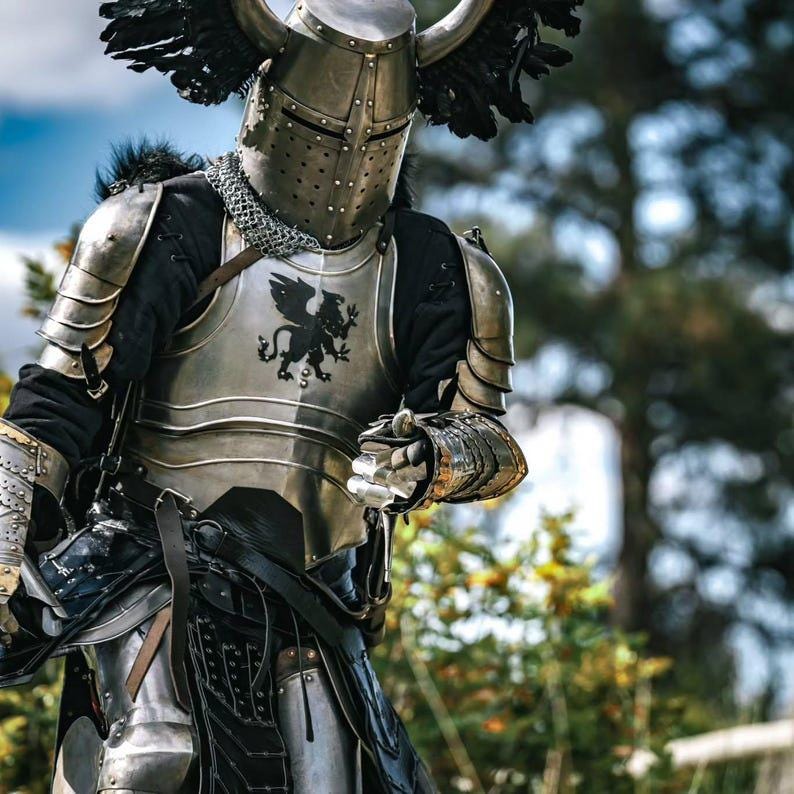 Articulated gauntlets with gold-accented detailing and engraved surfaces, offering full hand protection in the knight armor set.
