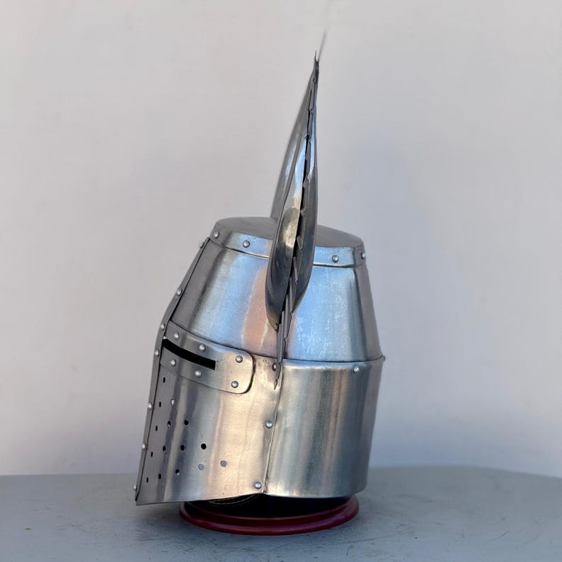Close-up of Templar knight helmet with polished steel finish and detailed brass cross emblem
