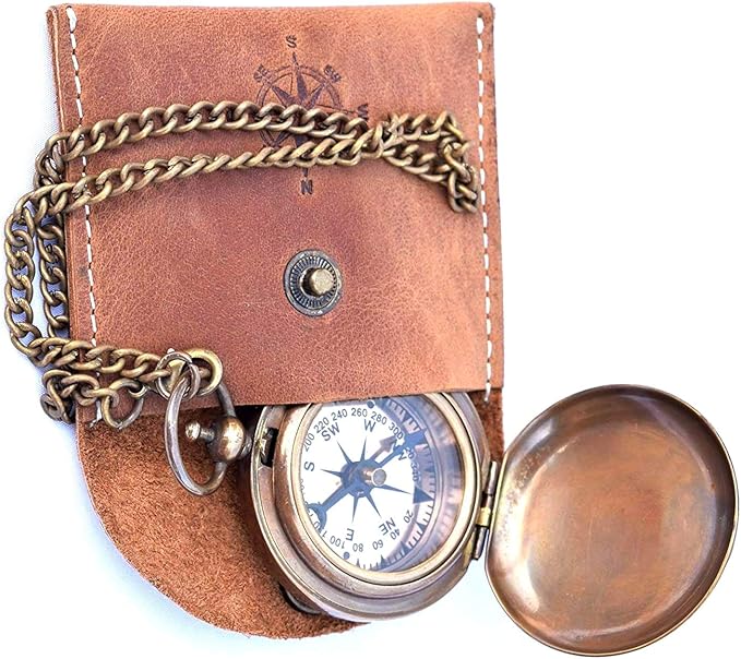 Close-up of vintage-style brass compass with copper rose dial
