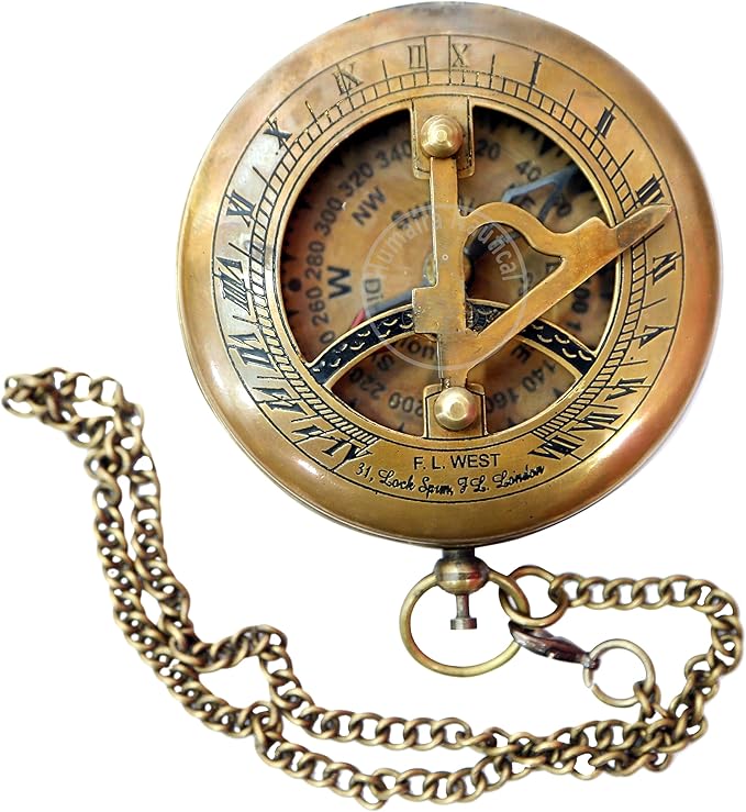 Top view of push-open brass compass showing detailed sundial design and needle.