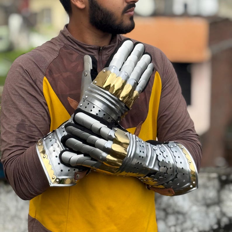 Articulated fingers on silver and gold steel gauntlets for LARP and cosplay