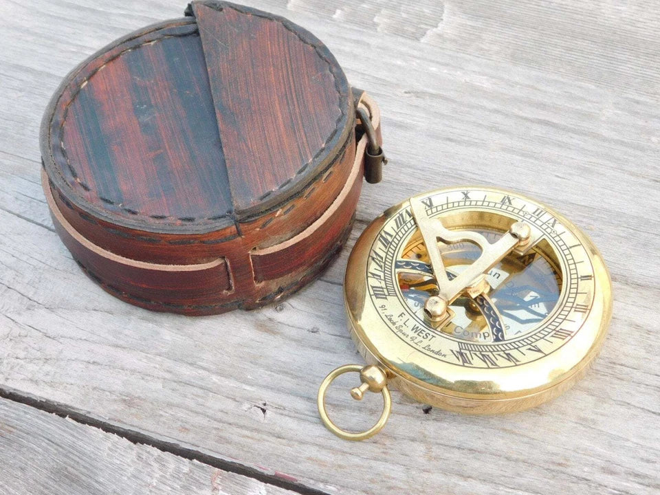 Close-up view of the Artisans Hub brass sundial compass with engraved leather pouch

