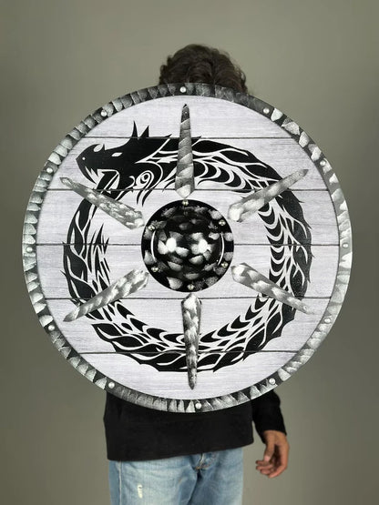 Person picking up Artisans Hub Dragon Shield, authentic Viking cosplay accessory

