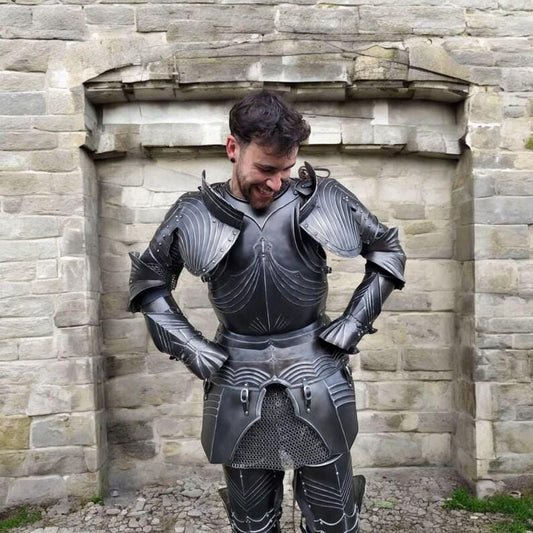 Front view of the handcrafted black gothic knight full body armor suit made from 18 gauge steel, fully assembled and displayed upright.

