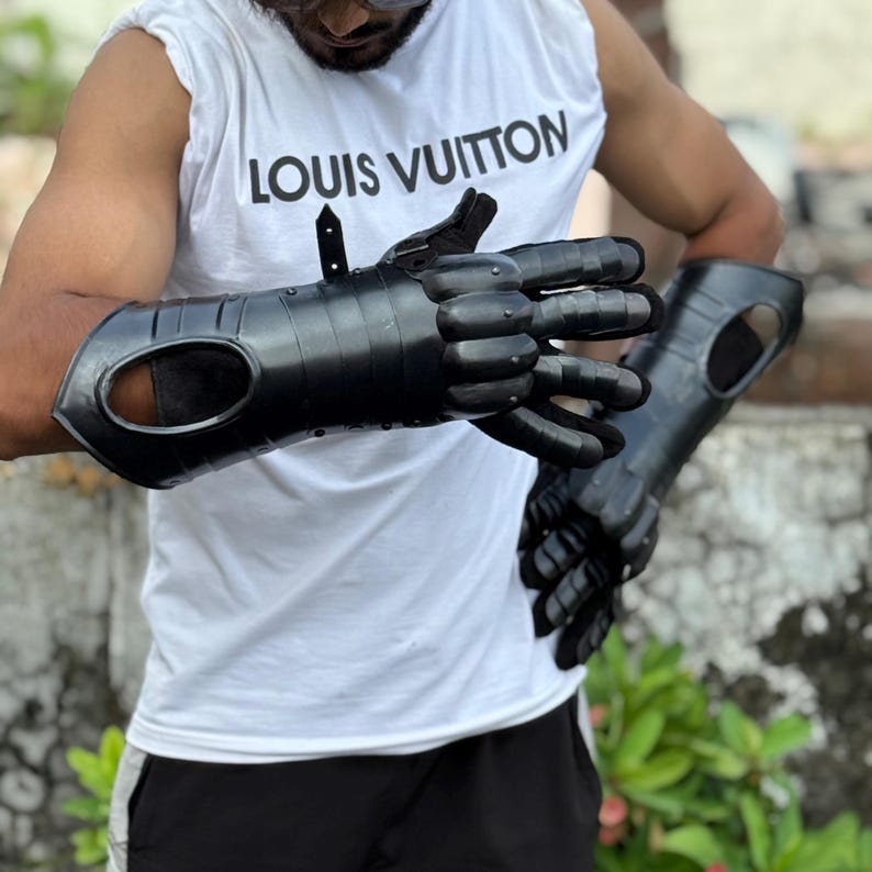Blackened steel gauntlets with adjustable straps perfect for LARP armor and cosplay events