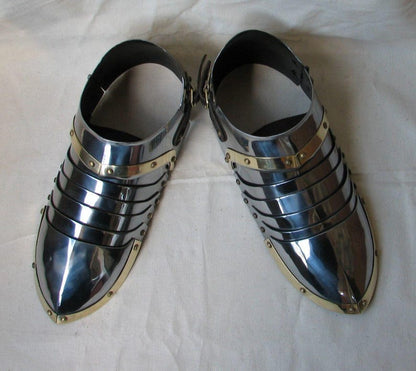 Close-up of brass steel sabatons showing fine craftsmanship and rolled edges

