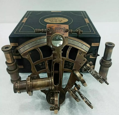 Brass nautical sextant instrument housed in an engraved wooden display case


