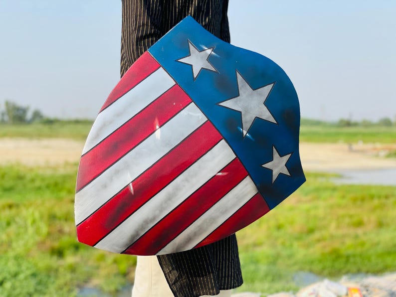 Close-up of the Captain America Damage Shield showing detailed battle damage and paintwork