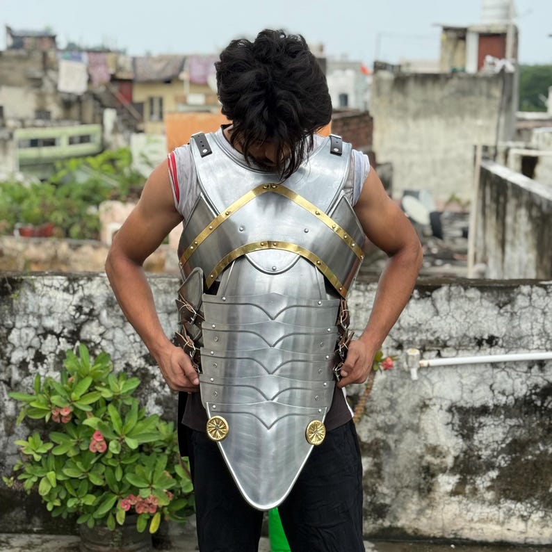 Side angle of Cuirass of Aegis Prime showing golden accents and articulated steel design