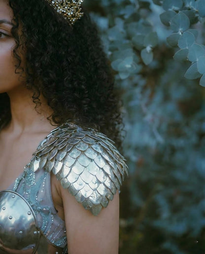 Dragon scalemail shoulder pauldrons in stainless steel, part of a knight cuirass armor for her fantasy cosplay